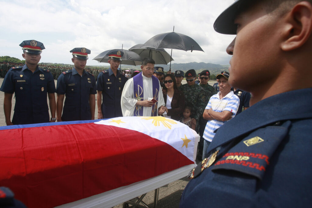 A military chaplain consoles a family in Zamboanga City, Philippines, Jan. 31. Pope Francis said military chaplains must also assist soldiers traumatized by war experience. (CNS photo/Laurenz Castillo, EPA)