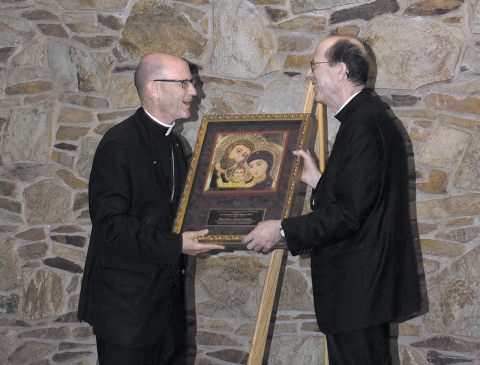 Bishop Thomas J. Olmsted presents the Evangelium Vitae Award to Bishop James Conley of Lincoln, Nebraska at a banquet following the White Mass at the Phoenix Convention Center Oct. 17. Bishop Conley served as the guest homilist for the Mass and keynote speaker for the banquet. (Photo courtesy of Stuart Moffitt)