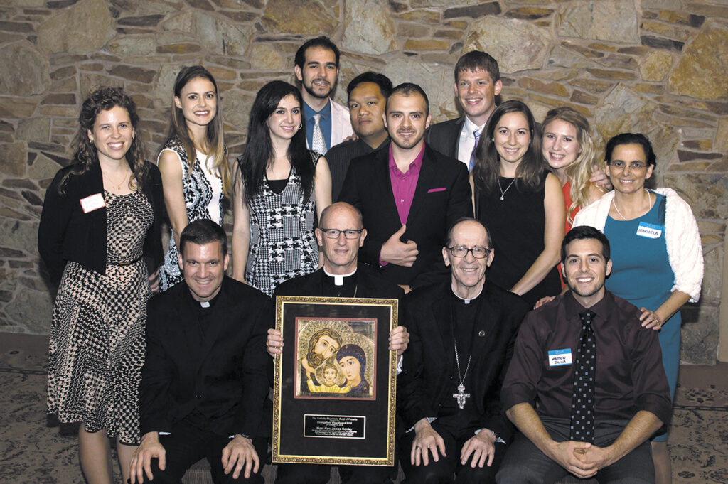 Bishops Olmsted and Conley pose with Franciscan Father Zygmunt Mazanowski (front row, far left), the new chaplain for the Catholic Physicians' Guild of Phoenix, guild treasurer Dr. Maricela P. Moffitt (center row, far right) and medical, dental and P.A. students. (Photo courtesy of Stuart Moffitt)