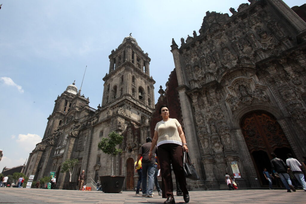 People walk outside the Metropolitan Cathedral in 2013 in Mexico City. Mexican Foreign Minister Claudia Ruiz Massieu has confirmed that Pope Francis will visit the capital, along with the states of Chihuahua and Chiapas, on the northern and southern borders respectively, and Michoacan in western Mexico. (CNS photo/Alex Cruz, EPA)