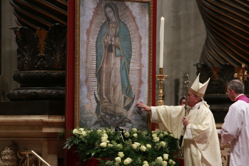 Pope Francis touches an image of Our Lady of Guadalupe at St. Peter's Basilica Dec. 12, 2014. (Daniel Ibanez/CNA)