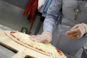 Priests and sisters made St. Vincent de Paul's regular pizza night a reality Oct. 30. (Ambria Hammel/CATHOLIC SUN)