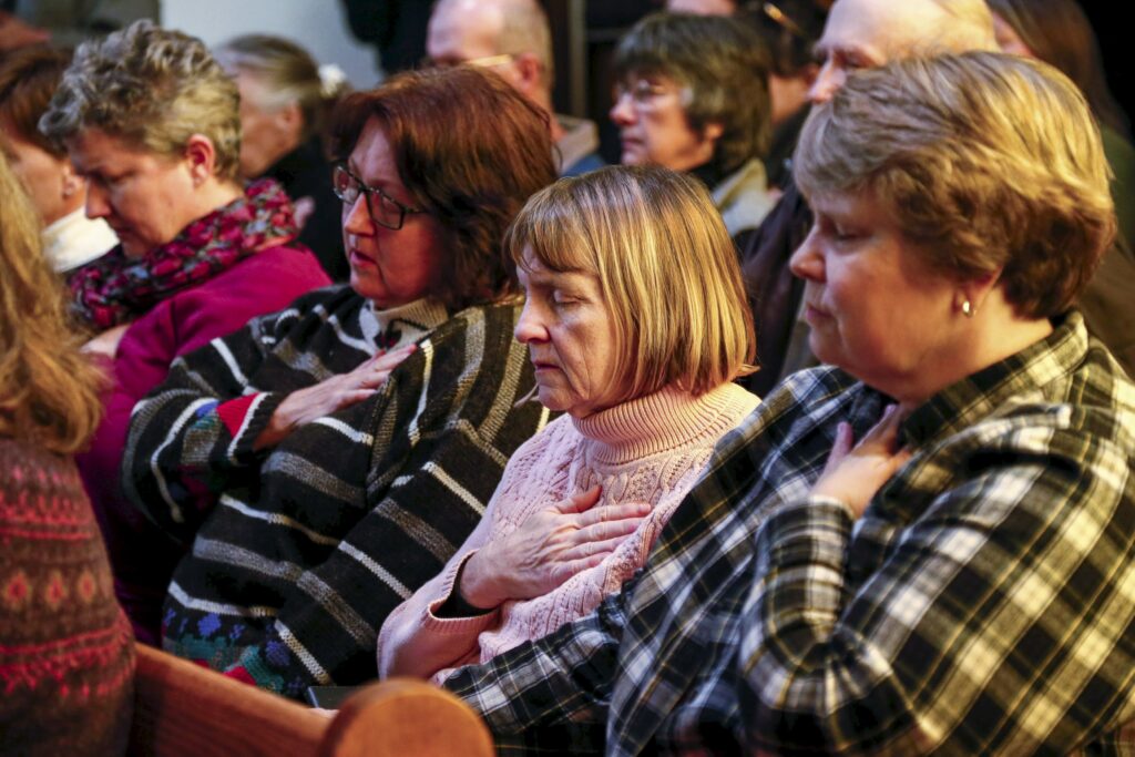 People pray during a vigil at All Souls Unitarian Universalist Church Nov 28, the day after a gunman opened fire on a Planned Parenthood clinic in Colorado Springs, Colo. Police say Robert Lewis Dear killed three people during the shooting rampage and hours-long standoff at the clinic and was later taken into custody. (CNS photo/Isaiah J. Downing, Reuters)