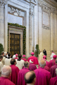 Pope Francis stands in front of the Holy Door in early April prior to first vespers of Divine Mercy Sunday in St. Peter's Basilica at the Vatican. The pope says he wants the Year of Mercy to usher in a "revolution of tenderness." (CNS photo/Andrea Solaro, Reuters pool) 