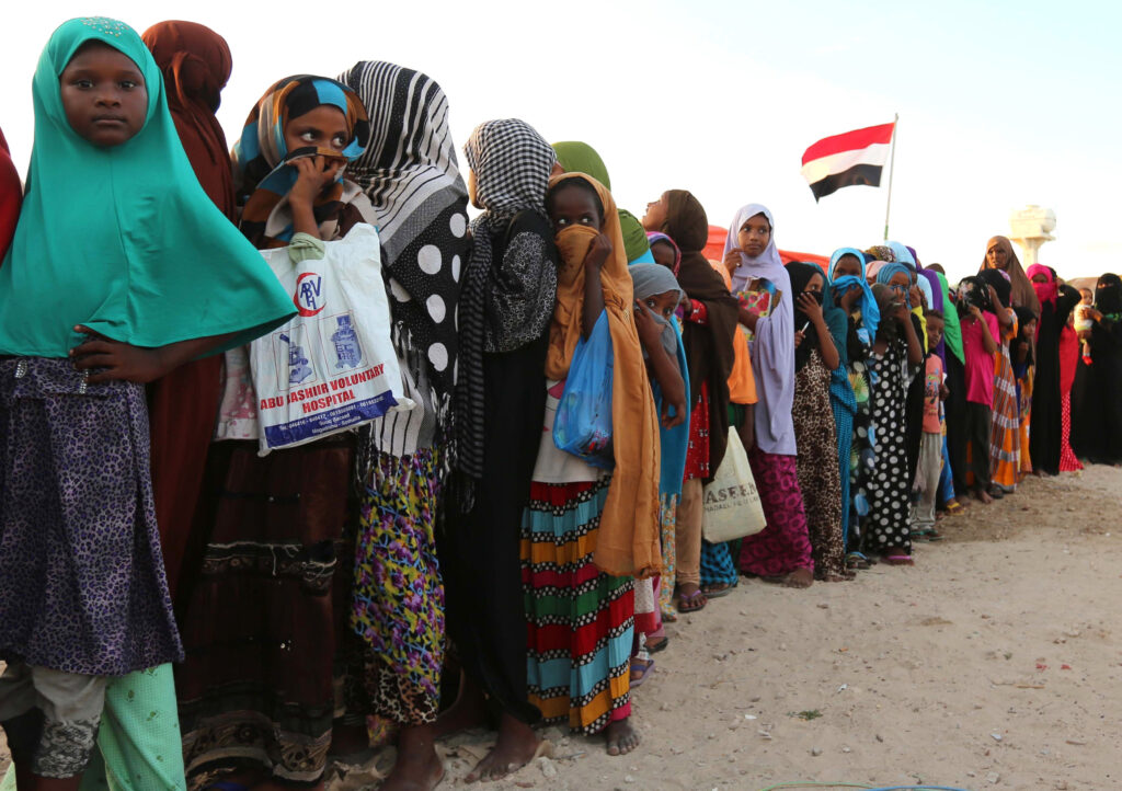Yemeni refugees wait in line for food rations Dec. 16 at a makeshift camp in Somalia's capital, Mogadishu. (CNS photo/Feisal Omar, Reuters)