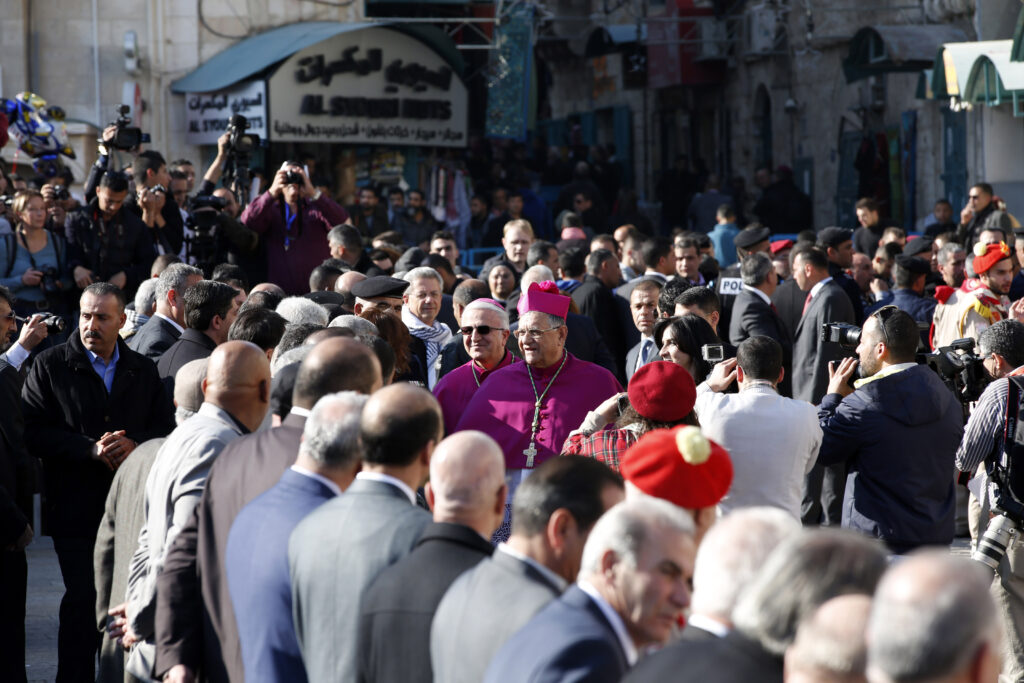 Latin Patriarch Fouad Twal of Jerusalem proceeds to Manger Square to lead the annual Christmas Eve procession into the Church of the Nativity in Bethlehem, West Bank. (CNS photo/Abed Al Hashlamoun, EPA)