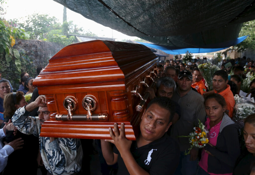 The coffin of Gisela Mota, former mayor of Temixco, Mexico, is carried out of her home Jan. 3. Mota was killed Jan. 2, one day after taking oath of office. (CNS photo/Margarito Perez, Reuters)
