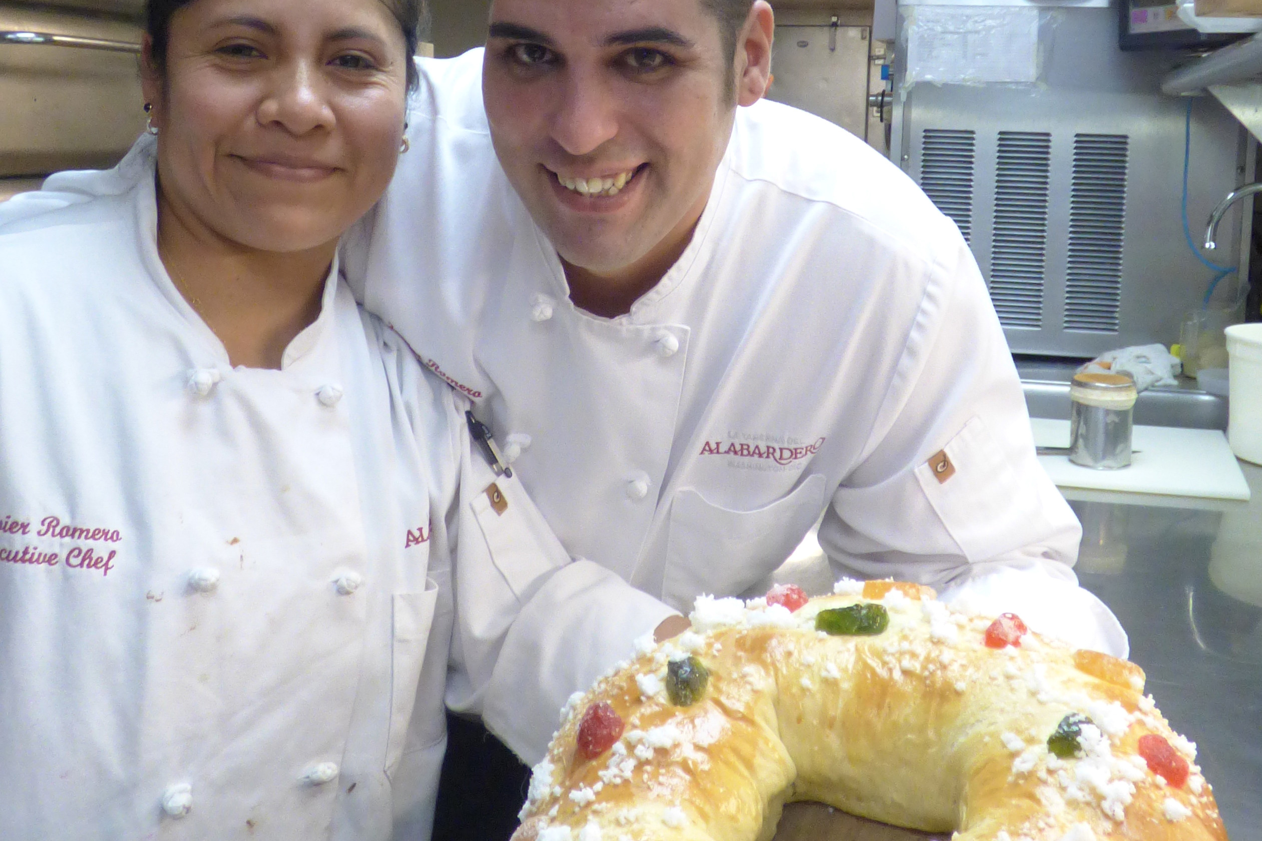 Margarita Castillo, chief pastry chef at Washington's Taberna del Alabardero, and Javier Romero, executive chef, display a finished roscon de reyes, a cake traditionally savored during the Epiphany in Mexico and Spain. The cake is similar to the king cake, but is starting to appear more often in January at the tables of immigrants living in the U.S. (CNS photo/Rhina Guidos)