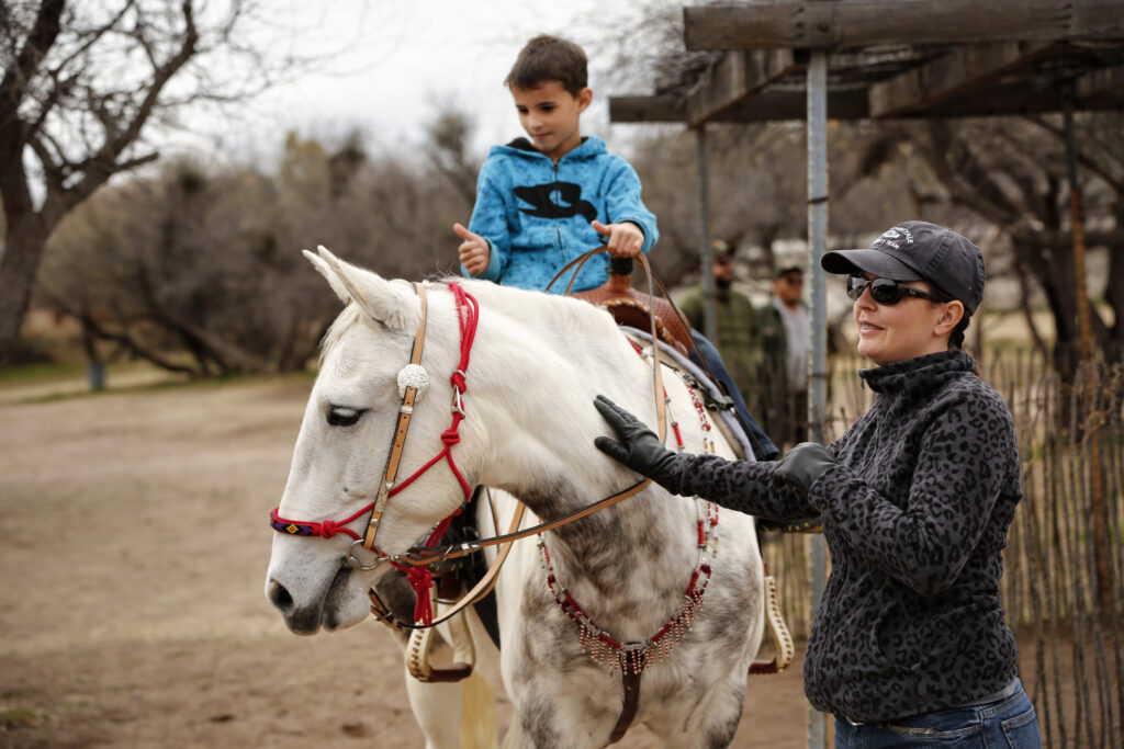 Desirae Steenken and her 7-year-old son, Draven Lee, admire Fabianna, a Wilbur-Cruce Spanish Barb horse, during the Kino Legacy Day at Tumacacori National Historical Park Jan. 10 in Tumacacori, Ariz. The now-endangered breed was brought to America by Europeans and was used by explorers and missionaries, including Fr. Eusebio Francisco Kino, who traveled more than 15,000 miles by horseback in the Pimeria Alta region. (CNS photo/Nancy Wiechec)