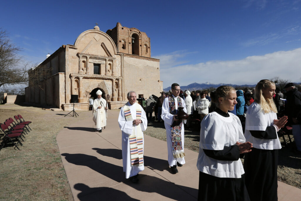 Bishop Gerald Kicanas of Tucson, Ariz., walks with his crosier after celebrating Mass outside the mission at Tumacacori National Historical Park in Tumacacori, Ariz., Jan. 10. The Mass was part of the park's Kino Legacy Day marking the 325th anniversary of the Jesuit missionary's first visit to an O’odham village there. (CNS photo/Nancy Wiechec)