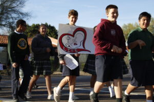 Most Holy Trinity seventh-graders march across the street to the parish hall for a prayerful life rally Jan. 22. (Ambria Hammel/CATHOLIC SUN)