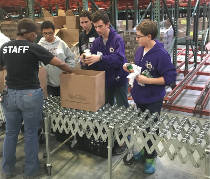 Freshmen at Notre Dame Preparatory load boxes with food for distribution at St. Mary's Food Bank in Phoenix. This is part of the school's Freshman Plunge program where freshmen students are introduced to a life of service to others. (courtesy photo)