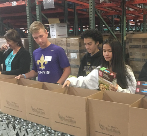 Freshmen at Notre Dame Preparatory load boxes with food for distribution at St. Mary's Food Bank in Phoenix. This is part of the school's Freshman Plunge program where freshmen students are introduced to a life of service to others. (courtesy photo)