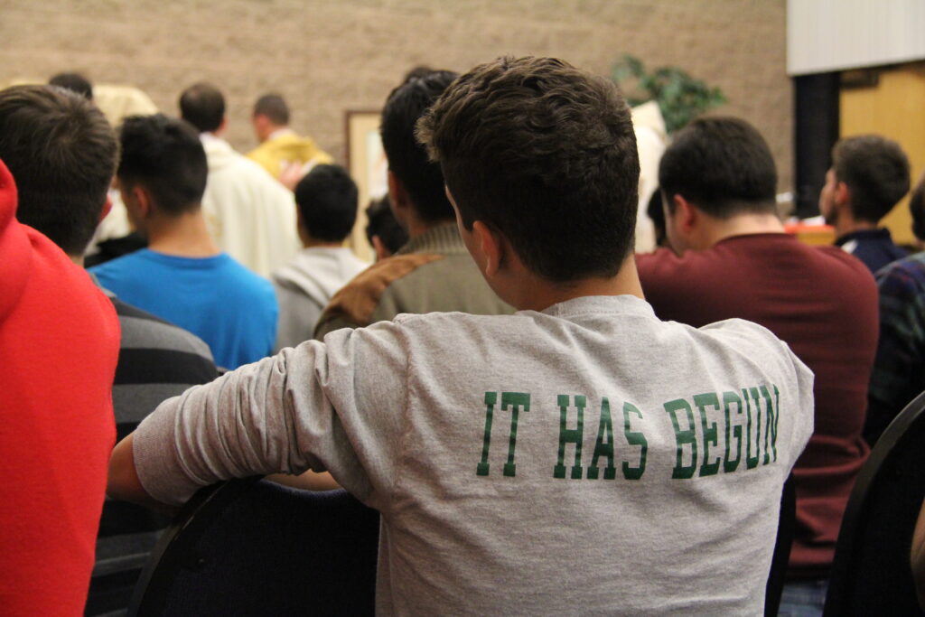 More than 200 Catholics kneel in prayer during the first Young Men's Conference Jan. 2 at St. Paul Parish (NAME/Catholic Sun)